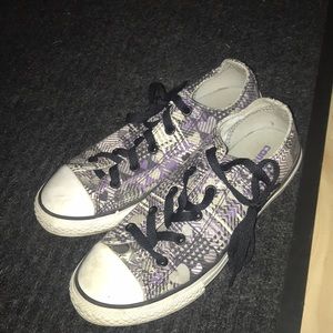 Black, purple, grey, and white kids converse.